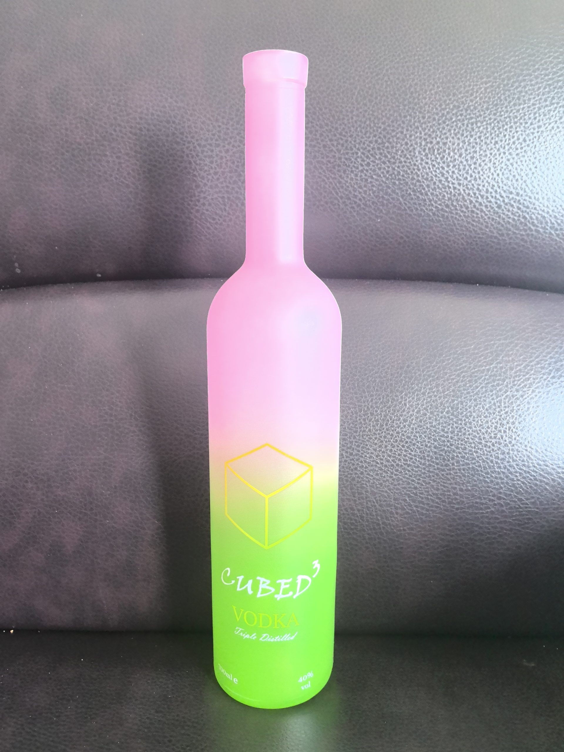 Pink-to-green gradient CUBED³ vodka bottle labeled VODKA, Triple Distilled, 700ml e, and 40% vol.